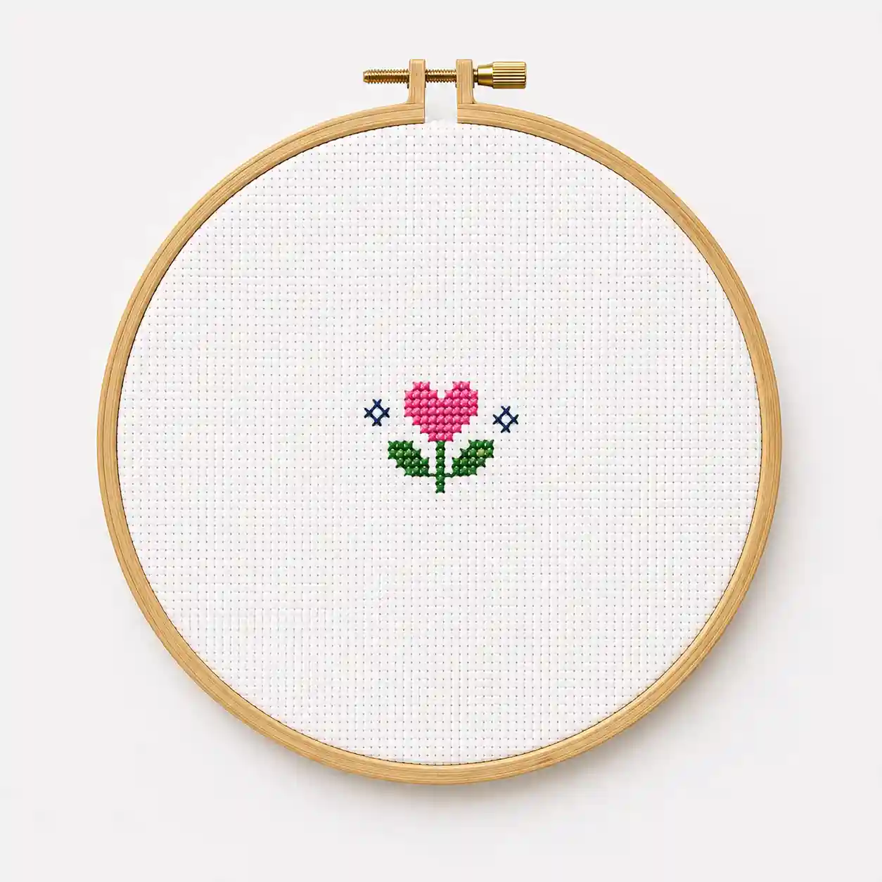 A single small heart-and-flower motif hooped with generous plain fabric around it