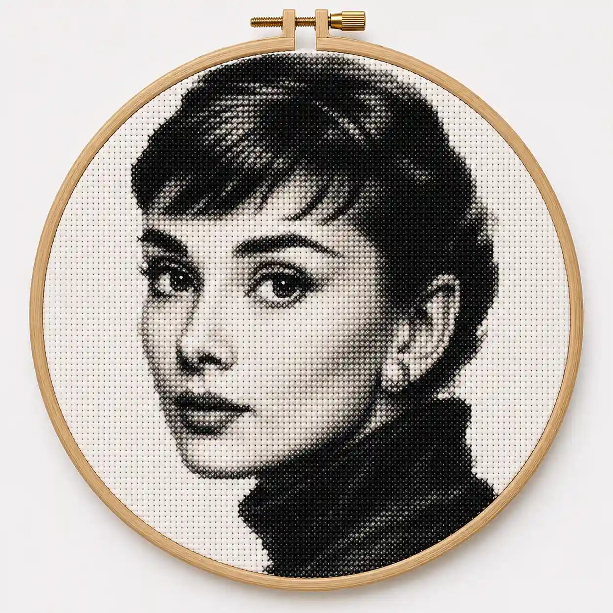 A dense black-and-white cross-stitch portrait rendered with fine tonal shading