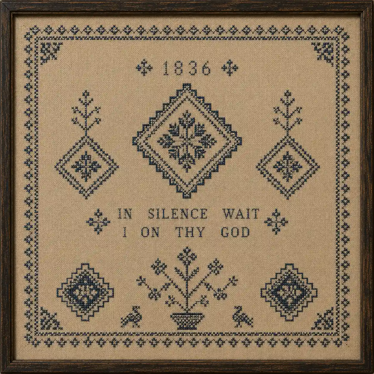 A restrained geometric sampler in blue and cream with diamond motifs and plenty of plain linen